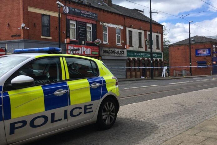 Police are questioning a man on suspicion of murder following a fatal stabbing in Oldham town centre in the early hours of the morning