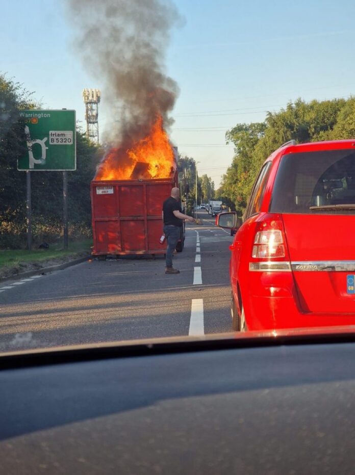 There are delays on the A57 heading towards Irlam as fire services deal with a blaze on a skip lorry
